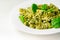 Pesto and pine nut pasta salad, fusilli pasta with regato cheese and baby spinach coated in basil pesto