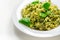 Pesto and pine nut pasta salad, fusilli pasta with regato cheese and baby spinach coated in basil pesto