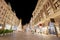 Pestsaule between illuminated buildings during night at Graben street in Vienna, Austria