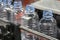 The PET bottles in the rail on the conveyor belt for filling process in the drinking water factory.