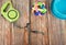 Pet leashes with rubber toy and bowl on wooden background