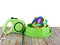 Pet leashes with rubber toy in bowls on wooden table and white background