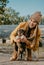 Pet Love. Young happy woman plays with puppies in the autumn park. Authentic moments of joy girl playing with stray dogs