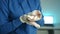 Pet mouse sits in hands of female veterinarian and sniffs around