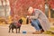 A pet owner pouring water for his friend to the bowl