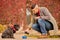 A pet owner pouring water for his friend to the bowl