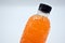 PET plastic bottles Polyethylene terephthalate black lid with fresh orange juice On a white background