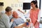 Pet Therapy Dog Visiting Senior Male Patient In Hospital