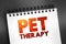 Pet therapy - guided interaction between a person and a trained animal, text concept on notepad