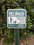 Pet waste sign surrounded by kudzu