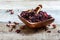 Petals of hibiscus tea in a wooden bowl.