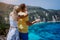 Petani view point young woman closing her boyfriend eyes in front of gorgeous seascape panorama. Turquoise Petani beach