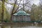 PETERHOF, RUSSIA - MAY 10, 2015: Decorative pavilion with green roof near the pond and fountain