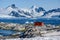 Petermann Island, beautiful Antarctic Island with penguins on rocks, abandoned station and snow covered mountains behind Ocean.