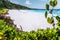 Petite Anse paradise beach summer vacation vibes framed by green foliage. La Digue island, Seychelles