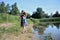 Petite woman wearing dress at lake