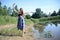 Petite woman wearing dress at lake