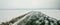 Petoskey Harbor Breakwater in spring with frozen lake