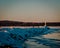 Petoskey, MI /USA - March 3rd 2018:  Lone tourist visiting a frozen lighthouse in Petoskey Michigan
