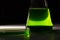 Petri dishand retort with green and blue with a chemical reagent. Chemical experiment with Laboratory glass