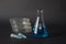 Petri dishes, erlemnmeyer flask and eppendorf tubes with blue li