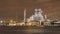 Petrochemical industry next to a river with a dramatic cloudy sky, Port of Antwerp