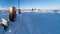 Petrol and diesel pump surrounded by snow and illuminated by morning sunlight at a service station in Iceland after a heavy