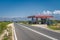 Petrol station between Nin and Zaton in Croatia with traffic on straight road