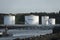 Petrol storage tanks on wharf with Green energy written on the side of the tank