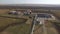 Petroleum plant with flare stack in field, aerial shot, oil and gas industry