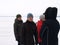 Petrozavodsk / Russia - March 1, 2018: girls in winter clothes walk on a frozen lake and laugh. Women communicate and smile in an