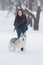 Pets Concepts and Ideas. Happy and Smiling Caucasian Brunette Woman Playing with Husky Dog Outdoors in Park