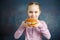 Petty Little Girl eating burger, following fastfood - Image