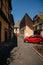 Peugeot car parked in front of Alsatian buildings