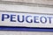 Peugeot logo and text sign front of bike car shop dealership store
