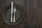 Pewter plate and vintage cutlery on rustic dark wooden backgroun