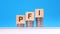 pfi - text on wood cube block stack with coins