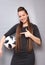 Ph1. A beautiful young lady with long hair in an elegant dress. Posing with a soccer ball.
