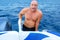 Phandsome man in the sea on a boat swimming, the concept of recreation and tourism. vacation