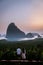 Phangnga Bay during sunrise, couple watching sunrise at the viewpoint Samet Nang Shee Thailand Phangnga province