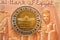 The Pharaohs golden parade 3-4-2021 from the obverse side of 1 LE EGP coin one Egyptian pound money on a blurred background