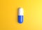 Pharmaceutical medicine pills, tablets and capsules on yellow background