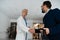 Pharmaceutical sales representative shaking hands with doctor in medical building. Doctor greeting hospital director