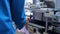 Pharmaceutical worker cleaning pharmaceutical equipment with air under pressure