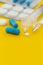 Pharmaceuticals antibiotics capsule pill medicine yellow background with copy space