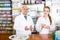 Pharmacist and assistant working at farmacy reception