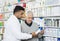 Pharmacist Assisting Customer In Buying Product