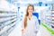 Pharmacist chemist woman standing in pharmacy