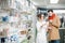 Pharmacist with client in the pharmacy store