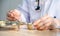 Pharmacist counting pills or medicine in stainless steel containers on the table for dispensing customer or patient,